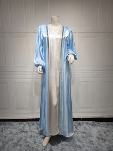Detailed close-up of light blue silk satin robe with silver sequin beadwork on the edges