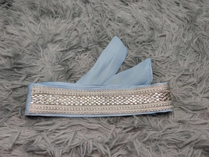 Detail of light blue chiffon belt with silver embroidery and sequin embellishments