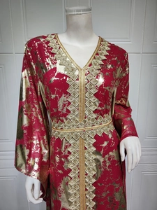 Detailed view of the V-neckline and gold geometric embroidery on a red chiffon dress