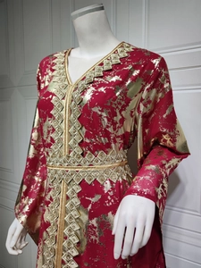 Detail of red chiffon kaftan dress featuring gold foil floral print and metallic embroidery