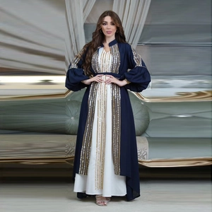 Detail of sequin embroidery on lantern sleeves of a navy blue kaftan formal dress