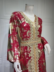 Detail of red chiffon kaftan with gold foil print and intricate metallic embroidery