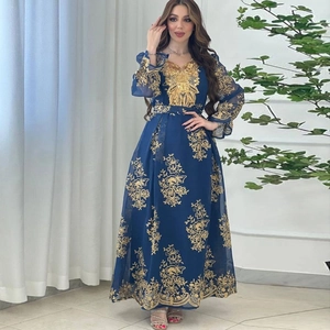 Detailed embroidery on a navy blue mesh long sleeve evening dress with golden floral patterns