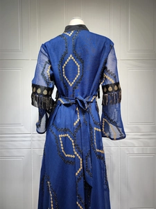 Detailed back view of navy blue sequin embroidery and long tassels on an evening kaftan dress