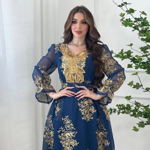 Detail of gold floral embroidery on navy blue ethnic maxi dress with lace collar