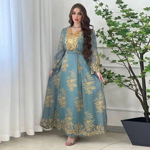 Intricate gold floral embroidery detail on a blue ethnic kaftan dress with belt