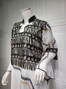 Detailed embroidery and gold sequin fringe on white evening dress with lace accents