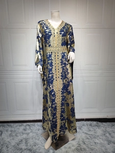 Detail of blue chiffon kaftan with gold foil texture and geometric embroidery