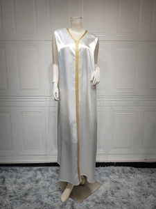 Detail of the white satin kaftan with luxury gold embroidery on the neckline and front seam