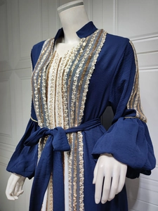Detailed embroidery with gold sequins on navy blue bubble sleeves and bodice