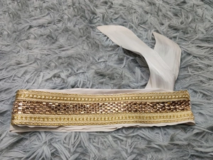 Detail of luxury rhinestone headband featuring gold braiding and brown faceted beads