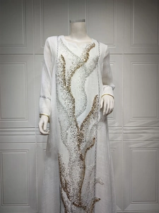 Detailed front view of white pullover maxi dress with gold and silver sequin patterns