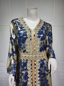 Close-up of navy chiffon dress featuring gold geometric embroidery and V-neckline detail