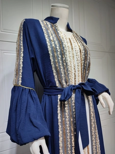 Detail of navy abaya with sequin embroidery and wide flared sleeves on mannequin