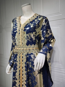 Close-up of navy chiffon kaftan with gold foil print and geometric embroidery detail