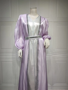Close-up of rhinestone trimmings and silver sequins on luxury satin kaftan dress
