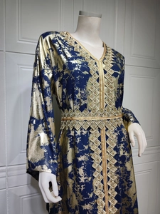 Detail of V-neck chiffon dress with gold foil print and geometric ethnic embroidery