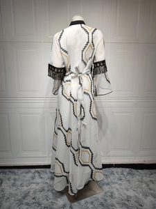 Detail of evening dress featuring black beaded fringe on bell sleeves and sequin embroidery