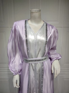 Close-up of V-neckline and silver sequin rhinestone trim on lavender satin dress