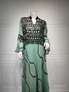 Detailed embroidery and sequins with long tassels on a light green evening dress