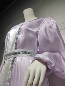 Detail of silver beadwork and sequins on lavender satin kaftan dress with belt