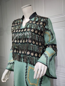 Detailed embroidery with black and gold sequin tassels on mint green evening dress