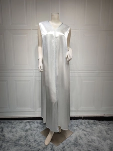 Detail showing the silver satin sleeveless dress with metallic woven trim and sleek texture