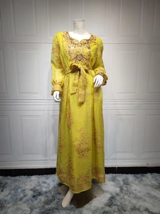 Close-up of golden floral embroidery and sequin details on a yellow ethnic maxi dress