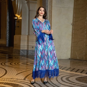 Close-up of deep blue long tassels on the printed geometric kaftan dress hem