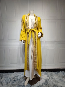 Close-up of ginger abaya featuring gold sequin embroidery and elegant puff sleeves