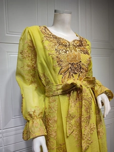 Detailed embroidery and sequins on bright yellow ethnic evening gown with floral patterns