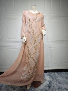 Elegant peach-colored maxi dress with intricate gold and silver sequin tree embroidery
