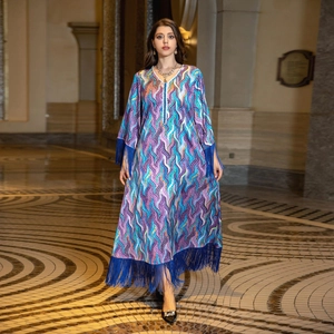 Detail of V-neck embroidery and abstract wave print on ethnic kaftan dress with blue tassels