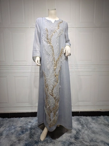 Elegant light blue long abaya dress with intricate gold and silver sequin embroidery.