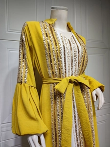 Detailed view of sequin embroidery on ginger yellow abaya dress with trumpet sleeves