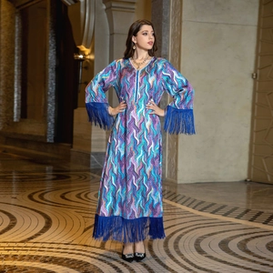 Detailed view of bohemian floral maxi dress with elegant deep blue tassels on hem and sleeves