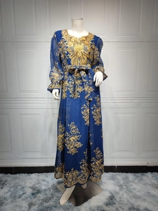 Detail of dark blue kaftan dress with intricate gold floral embroidery and sequins