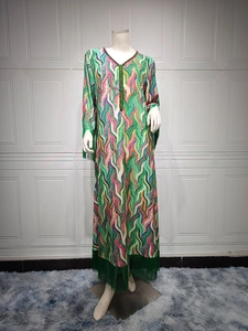 Close-up of ethnic kaftan dress with colorful wave print, V-neck, and green fringe detail
