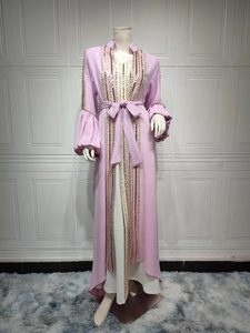 Detail of pink abaya with gold sequin embroidery and textured balloon sleeves