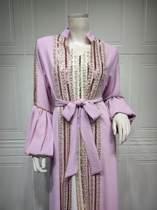 Detail of light purple kaftan dress with sequin stripes and elegant puff sleeves