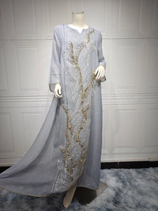 Elegant detail of sequin branch embroidery on light blue summer maxi dress for women