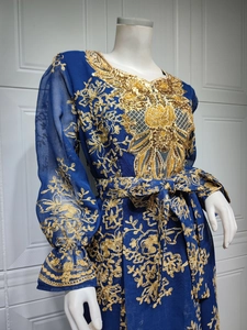 Close-up of golden embroidery and sequins on navy blue ethnic maxi dress with puff sleeves