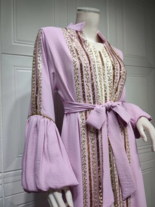 Close-up of lavender kaftan dress with vertical gold sequins and trumpet sleeves