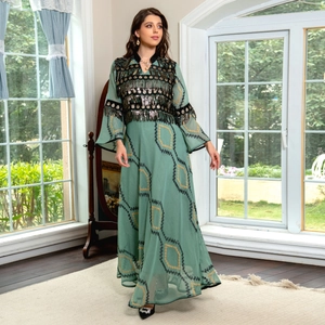 Dark green evening gown with gold sequins, tassel embroidery, and geometric print