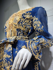 Detailed embroidery with gold thread and sequins on a navy blue ethnic party dress