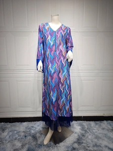 Close-up of colorful mosaic print maxi dress with deep blue fringe hem details