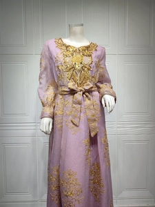 Detailed golden embroidery on lilac Moroccan caftan with sequins and waist belt