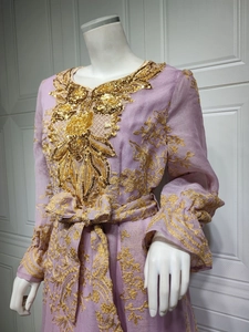 Detail of lavender dress featuring intricate gold embroidery and sequin floral patterns