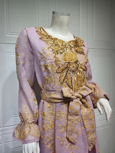 Detail of lavender ethnic dress showing intricate gold embroidery and sequin embellishments