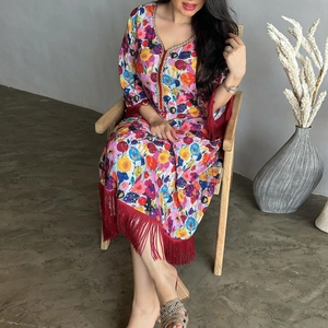 Detail of V-neckline with gold sequins and vibrant floral patterns on ethnic long dress